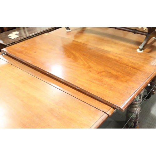 502 - A Victorian mahogany extending dining table with two extra leaves, on turned and castored supports, ... 