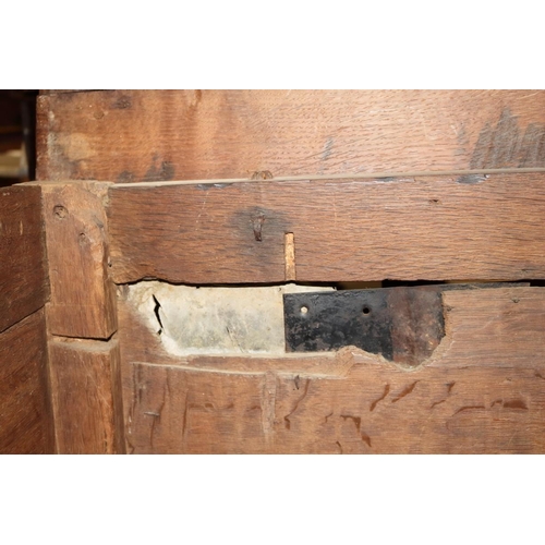 507 - An early 18th century chip carved coffer with triple panel lid, on moulded stile supports (retaining... 