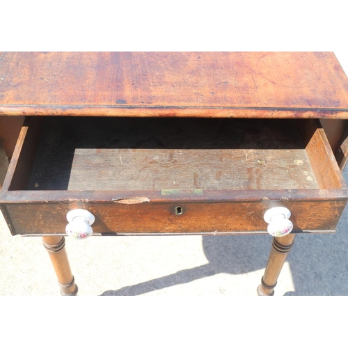 512 - A late 19th century mahogany Pembroke table, fitted one drawer with ceramic knobs, on slender turned... 