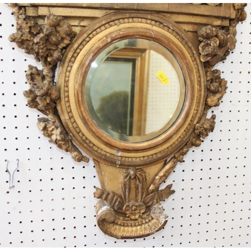 584 - A gilt framed circular mirror, decorated flowers and scrolls, 6 3/4