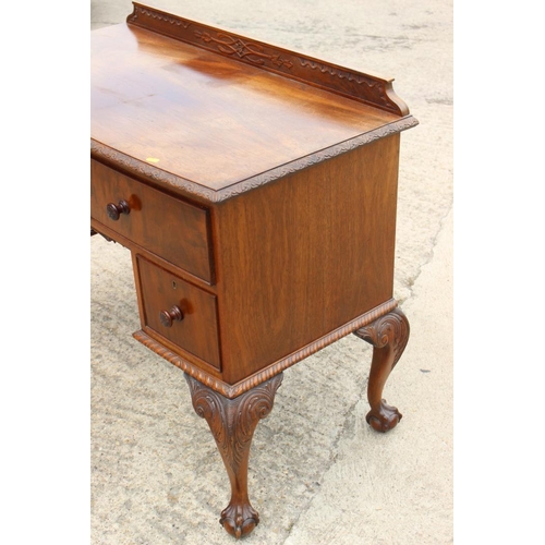 640 - A walnut bowfront desk, fitted one long and two deep drawers, on carved cabriole claw and ball suppo... 