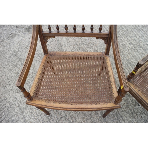 652 - An Edwardian carved frame cane seat and back settee and matching armchairs, an oak drop leaf dining ... 