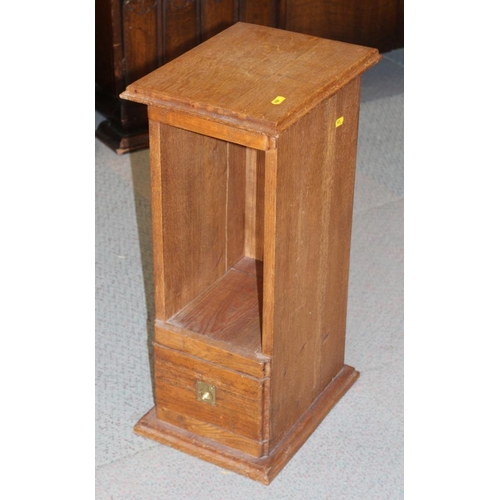 653 - A mahogany bowfront waterfall bookcase over cupboard, 27