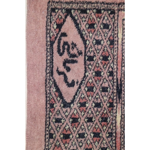 699 - A Bokhara rug with four panels on blue ground, 49