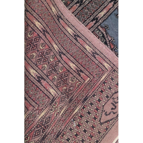 699 - A Bokhara rug with four panels on blue ground, 49