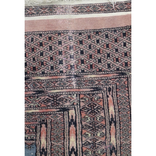 699 - A Bokhara rug with four panels on blue ground, 49