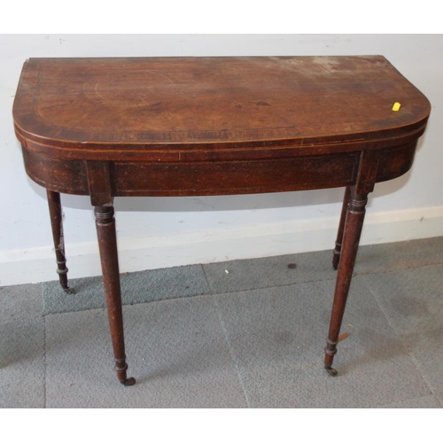 533 - A late Georgian mahogany and rosewood banded fold-over top 'D' shape tea table, on turned and castor... 