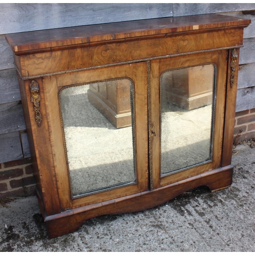 535 - A late Victorian walnut and banded credenza/pier cabinet enclosed two arch top mirror panelled doors... 