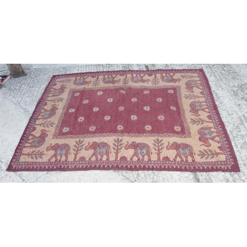 698 - A tapestry rug with elephant design in shades of red and fawn, 68