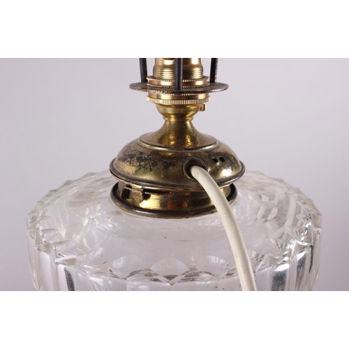 265 - An anodised brass oil lamp with cut glass reservoir and reeded column, on stepped base