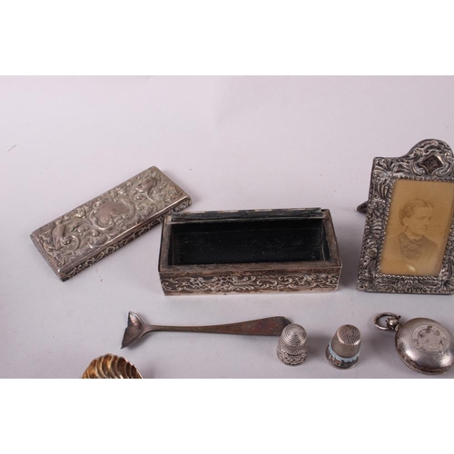 316 - A Georgian design silver shell-bowl caddy spoon, a silver sovereign case, a silver envelope stamp ca... 