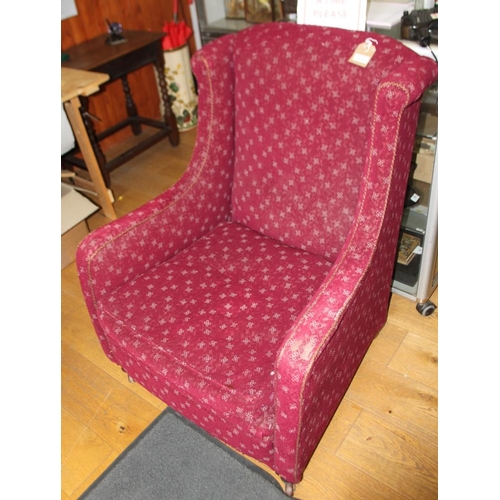 528 - A 19th century low seat square armchair, on castored supports