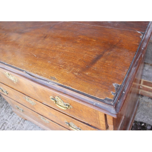 531 - An 18th century walnut and banded chest of three long graduated drawers with brass bail handles and ... 