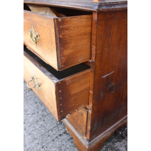 531 - An 18th century walnut and banded chest of three long graduated drawers with brass bail handles and ... 