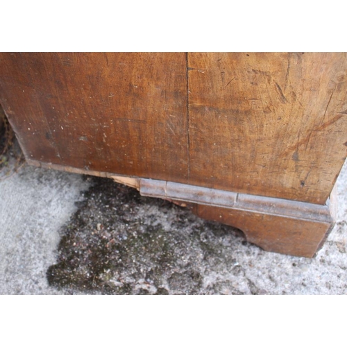 531 - An 18th century walnut and banded chest of three long graduated drawers with brass bail handles and ... 