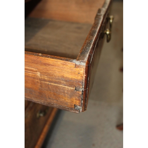 518 - A George III walnut and banded fall front bureau with fitted interior over two short and two long dr... 