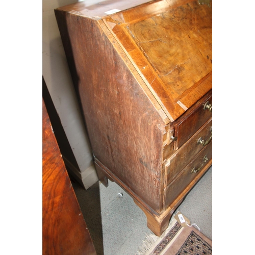 518 - A George III walnut and banded fall front bureau with fitted interior over two short and two long dr... 