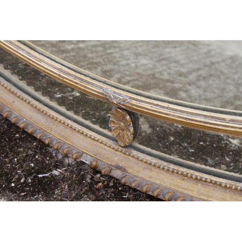 597 - A late Victorian oval moulded and gilt framed wall mirror, plate 30 1/4