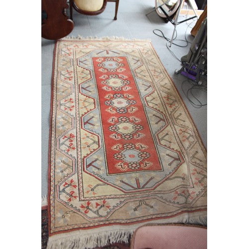 695 - A Kazak type rug with rust centre ground and geometric borders, 79