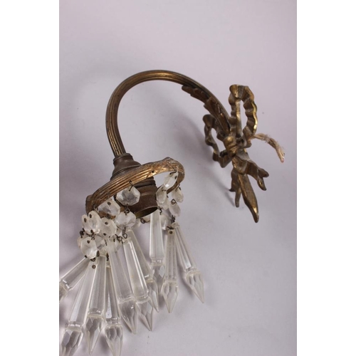 269 - A pair of gilt brass single light wall brackets, point drops with ribbon backs, 7