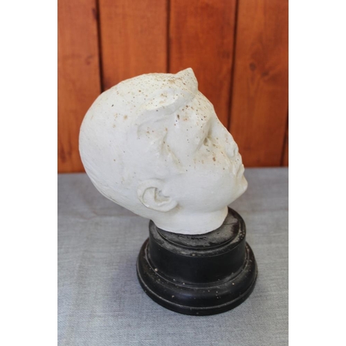 244 - A white marble bust of a young man, on ebonised base, 7 3/4