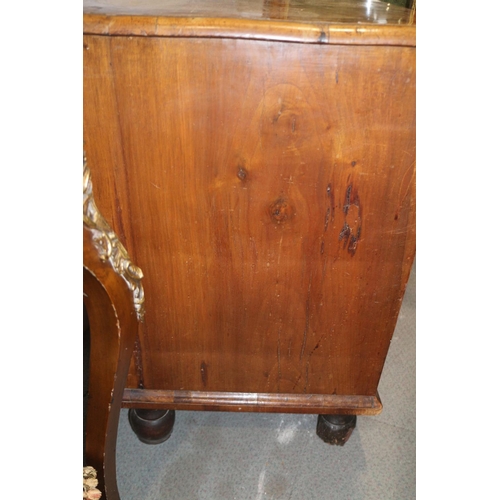 517 - A George III walnut and banded chest of four graduated long drawers with brass drop handles, on turn... 