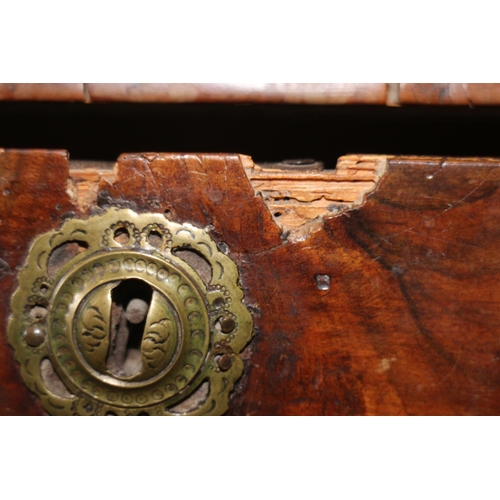 517 - A George III walnut and banded chest of four graduated long drawers with brass drop handles, on turn... 