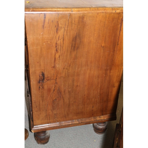 517 - A George III walnut and banded chest of four graduated long drawers with brass drop handles, on turn... 