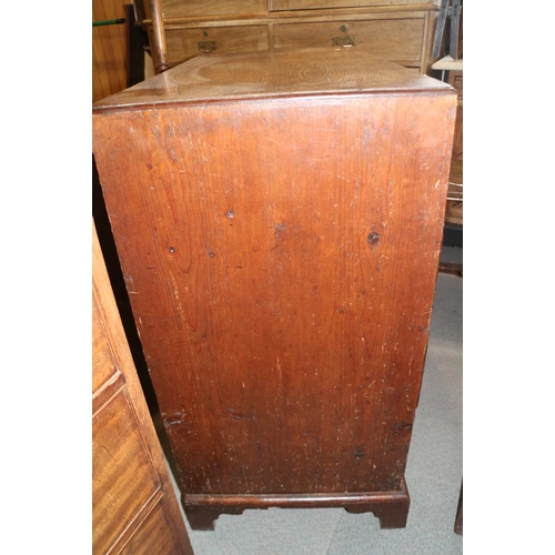 560 - A late Georgian walnut and banded chest of two short and three long drawers with brass handles, on b... 