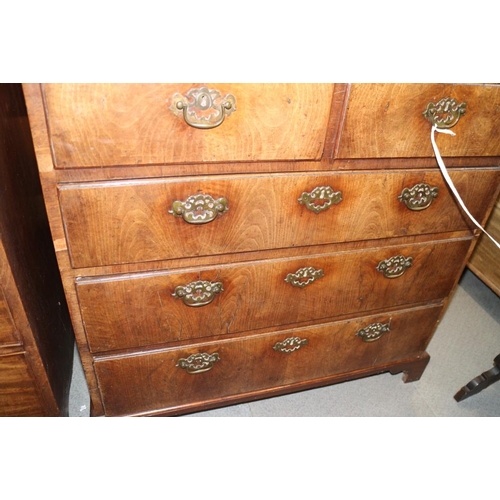 560 - A late Georgian walnut and banded chest of two short and three long drawers with brass handles, on b... 