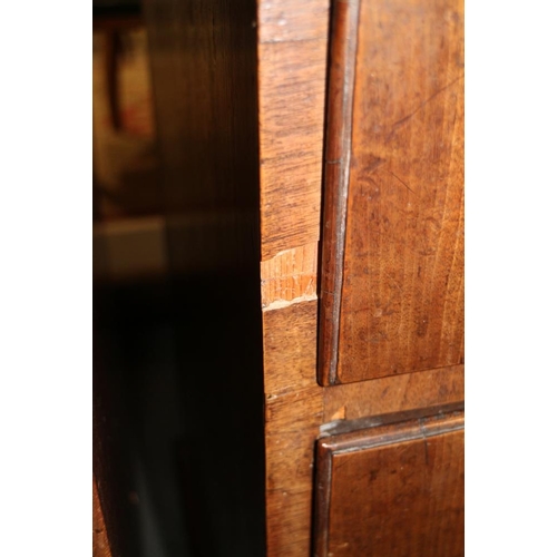 560 - A late Georgian walnut and banded chest of two short and three long drawers with brass handles, on b... 