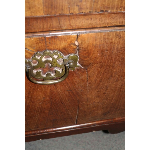 560 - A late Georgian walnut and banded chest of two short and three long drawers with brass handles, on b... 