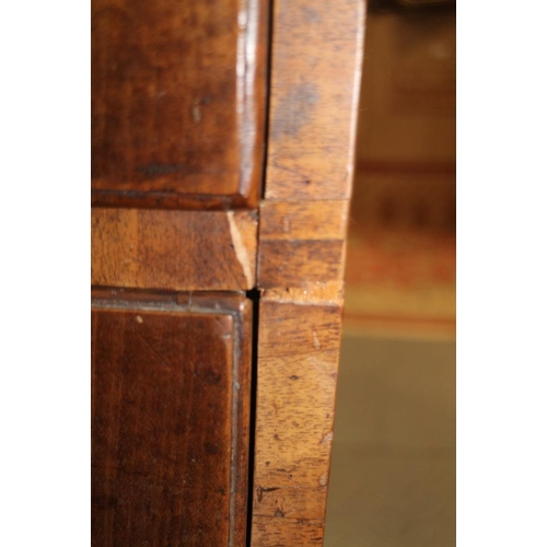 560 - A late Georgian walnut and banded chest of two short and three long drawers with brass handles, on b... 