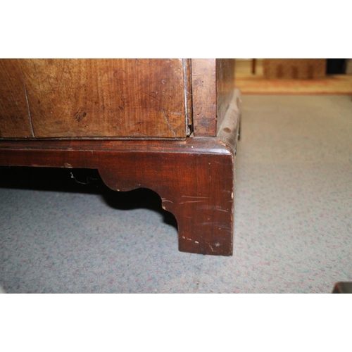 560 - A late Georgian walnut and banded chest of two short and three long drawers with brass handles, on b... 