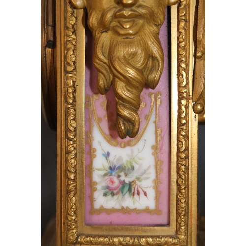 95 - An English gilt metal cased mantel clock with pink, gilt and floral spray dial and panels, and Roman... 