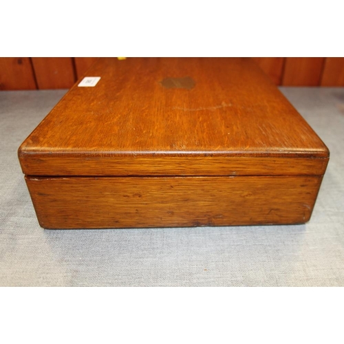 395 - An oak box containing a selection of modern ladies and gentlemen's wristwatches, spares, etc and a s... 