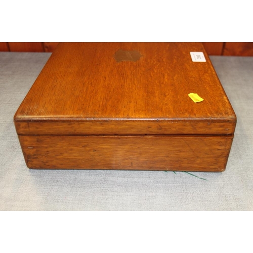 395 - An oak box containing a selection of modern ladies and gentlemen's wristwatches, spares, etc and a s... 