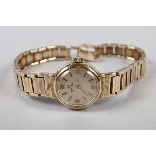 291 - A lady's Omega 9ct gold wristwatch and bracelet, 18.2g gross