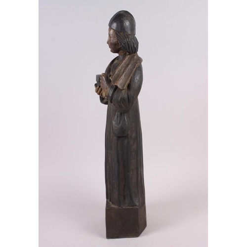 131 - An antique carved wood and painted wood figure of a priest, on square base, 22