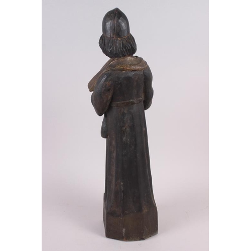 131 - An antique carved wood and painted wood figure of a priest, on square base, 22