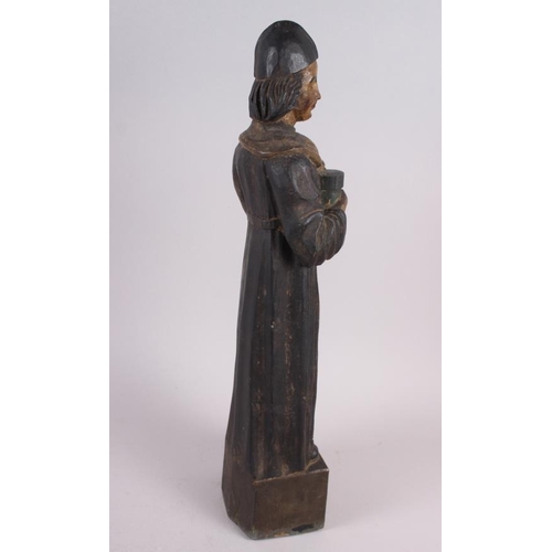 131 - An antique carved wood and painted wood figure of a priest, on square base, 22