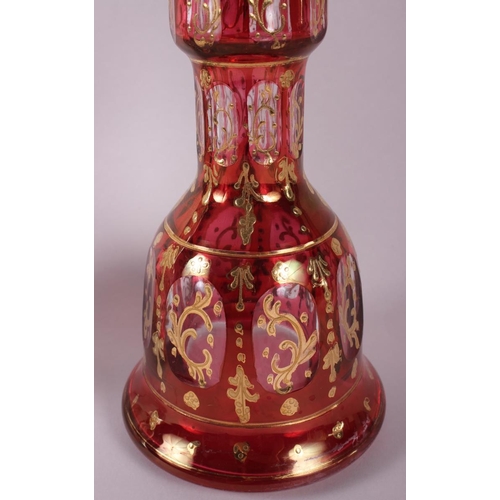 22 - A 20th century Bohemian ruby glass mallet-shaped vase with gilt decoration, 10