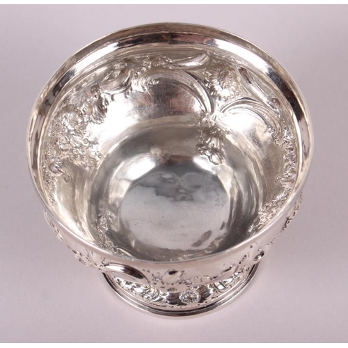 247 - A Georgian silver pedestal bowl with embossed floral decoration, 7.1oz troy approx