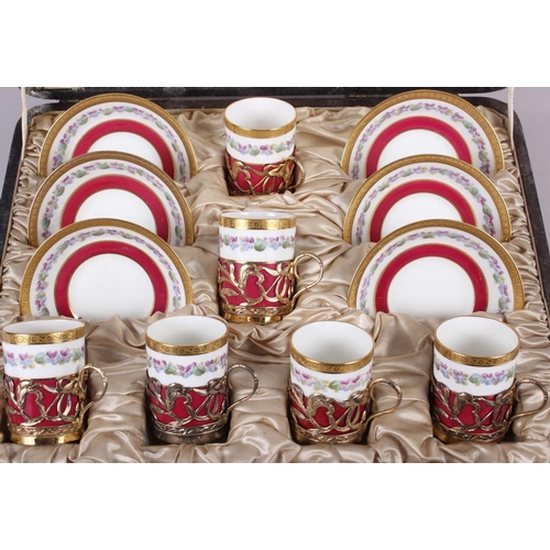 251 - A cased set of six Cauldron bone china coffee cans with silver gilt mounts and six matching saucers