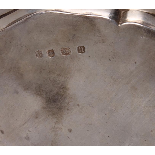 254 - A silver pie crust salver, raised on four hoof feet, 8