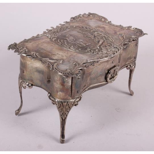 261 - A silver jewellery box, in the form of a dressing table fitted one drawer and with embossed decorati... 