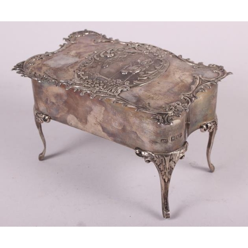 261 - A silver jewellery box, in the form of a dressing table fitted one drawer and with embossed decorati... 