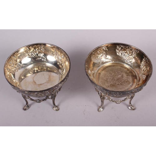 263 - A pair of Arts & Crafts style bonbon dishes with embossed floral decoration and cast stands, 9.7oz t... 