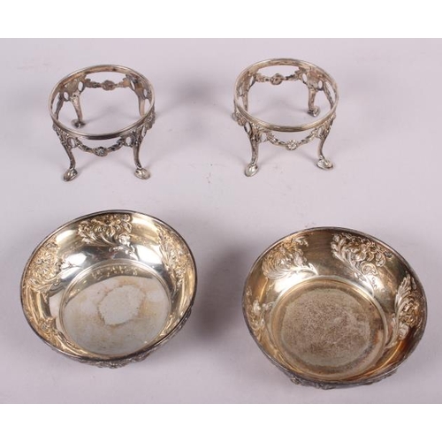 263 - A pair of Arts & Crafts style bonbon dishes with embossed floral decoration and cast stands, 9.7oz t... 