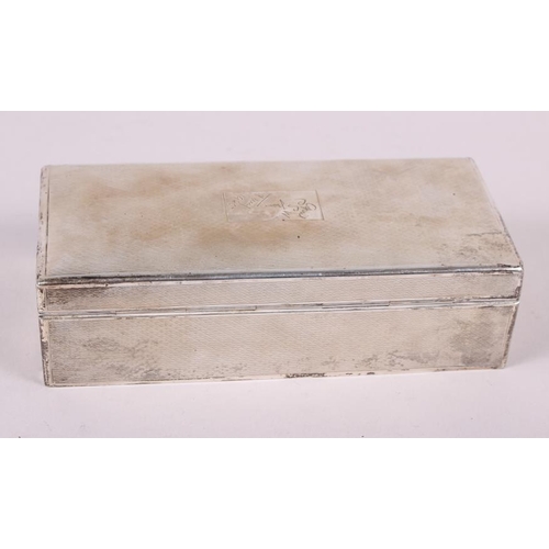 264 - A silver cigarette box with engine turned decoration, 7 1/2